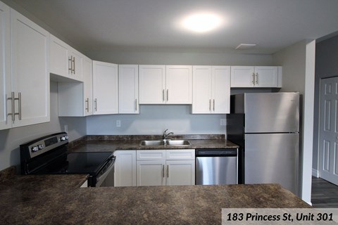 a kitchen with stainless steel appliances and white cabinets